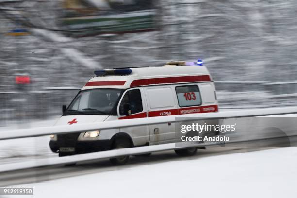 An ambulance passes on the road covered by snow during snowfall at the Kosygina Street in Moscow, Russia on January 31, 2018.