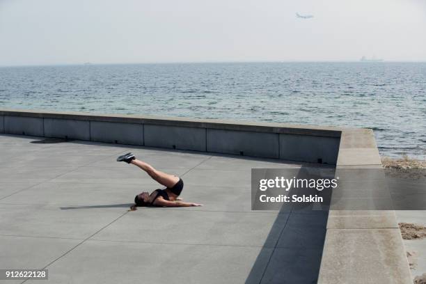 woman training outdoor on concrete surface - flatten the curve fotografías e imágenes de stock