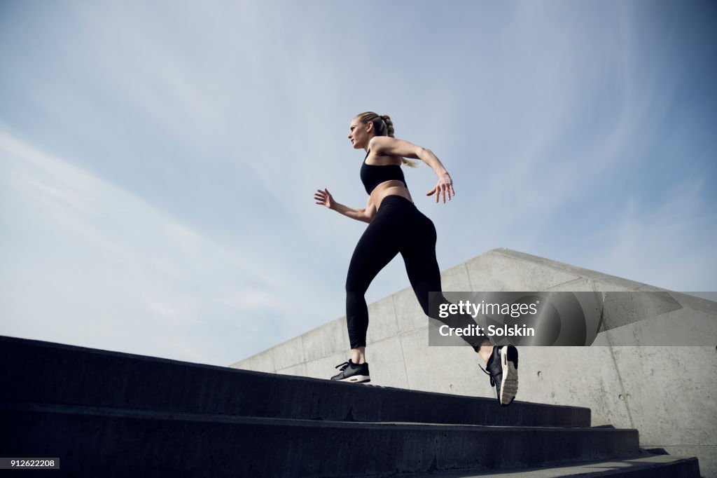 Sport trained woman running outdoors