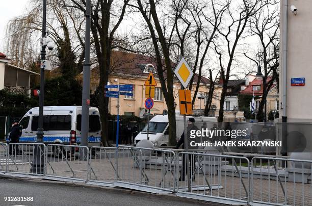 Police stand behind barriers around the Israeli Embassy in Warsaw on January 31 after a local governor, citing security concerns, banned traffic in...
