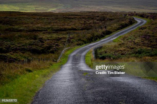 curving rural road in scottish countryside - アイラ ストックフォトと画像
