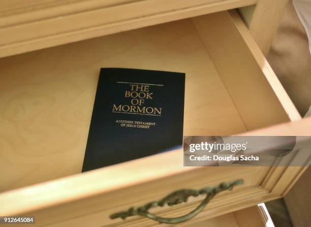 close-up of a book of mormon in the dresser drawer of a hotel room - mormonism stock pictures, royalty-free photos & images