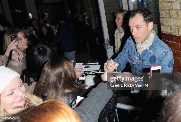 Jude Law signs autographs at the stage door after his performance in "Henry V" at the Noel Coward Theatre on December 11, 2013 in London, England.