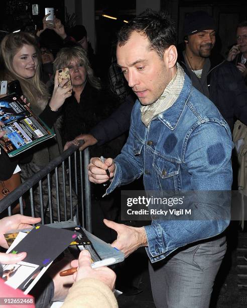 Jude Law signs autographs at the stage door after his performance in "Henry V" at the Noel Coward Theatre on December 11, 2013 in London, England.