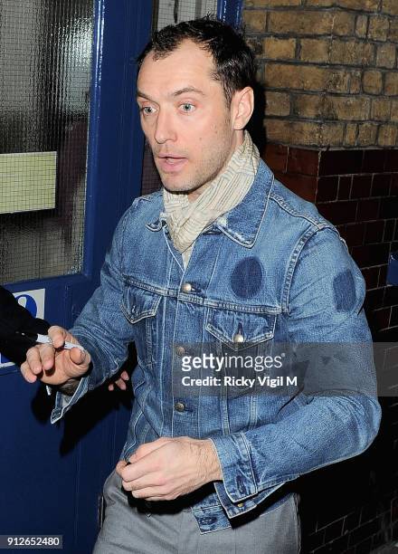 Jude Law signs autographs at the stage door after his performance in "Henry V" at the Noel Coward Theatre on December 11, 2013 in London, England.