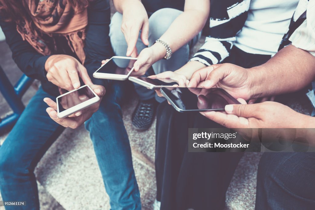 Group of people using smart phone for online shopping or ecommerce concept
