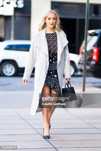 Nastia Liukin is seen wearing an Alice + Olivia coat, H&M top and skirt with a Yves Saint Laurent handbag in SoHo on January 31, 2018 in New York...