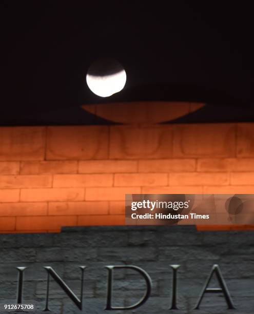 The moon is seen during a lunar eclipse referred to as the "super blue blood moon", at India Gate on January 31, 2018 in New Delhi, India. In rare...