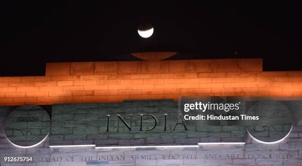 The moon is seen during a lunar eclipse referred to as the "super blue blood moon", at India Gate on January 31, 2018 in New Delhi, India. In rare...