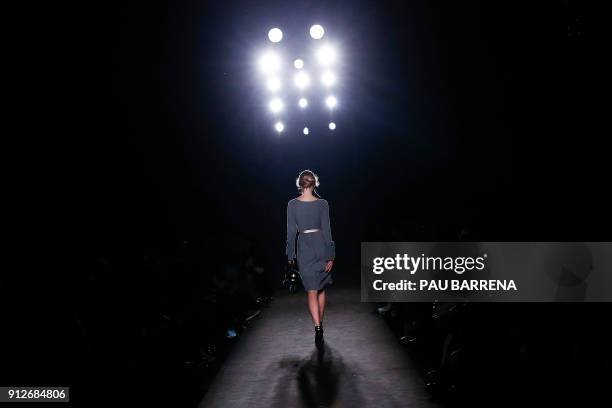 Model presents a creation by Wom & Now during the 080 Barcelona Fashion Week in Barcelona on January 31, 2018. / AFP PHOTO / PAU BARRENA