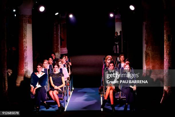 Models present creations by Wom & Now during the 080 Barcelona Fashion Week in Barcelona on January 31, 2018. / AFP PHOTO / PAU BARRENA