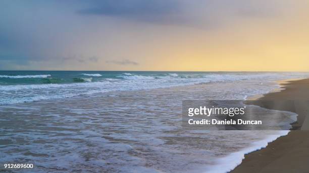 beach at sunset - wrightsville stock pictures, royalty-free photos & images