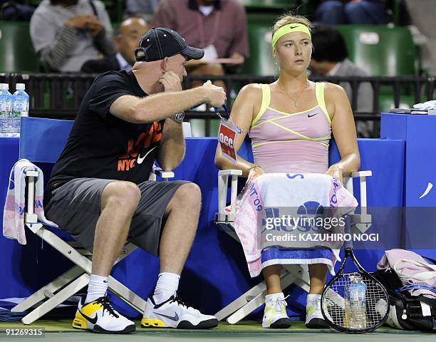 Maria Sharapova of Russia chats with her coach during her women's singles third round match against compatriot Alisa Kleybanova in the Pan Pacific...