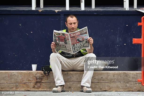 In this photo illustration a builder reads a copy of The Sun newspaper on September 30, 2009 in London, England. The Sun today led with the headline...