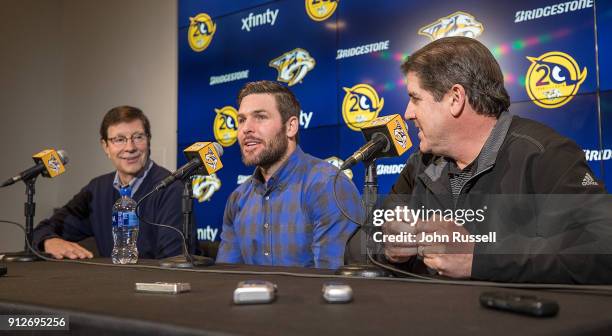 Nashville Predators GM David Poile announces Mike Fisher's return to play for the Predators as head coach Peter Laviolette looks on during a press...