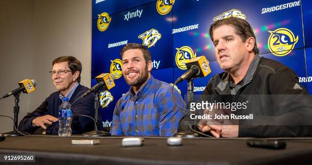 Nashville Predators GM David Poile announces Mike Fisher's return to play for the Predators as head coach Peter Laviolette looks on during a press...