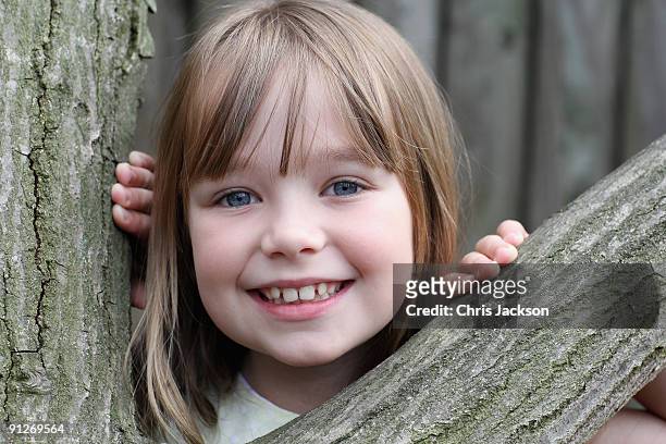 Singer Connie Talbot sits next to a tree as she takes part in a photoshoot at London Zoo on June 25, 2009 in London, England.