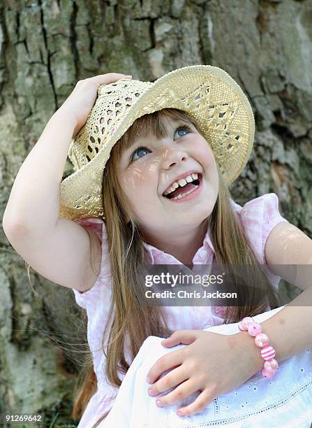 Singer Connie Talbot sits next to a tree as she takes part in a photoshoot at London Zoo on June 25, 2009 in London, England.