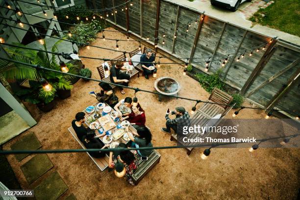 overhead view of friends dining during backyard barbecue - grill von oben stock-fotos und bilder