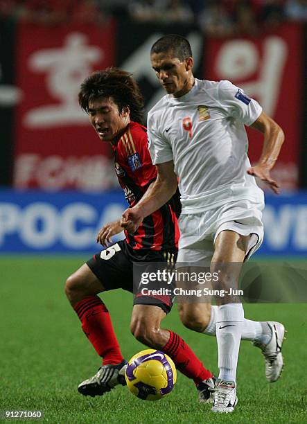 Go Yo-Han of FC Seoul and Magno Alves of Umm-Salal compete for the ball during AFC Champions League match between FC Seoul and Umm-Salal at Seoul...