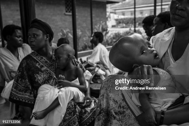 Mothers gather with their children on the compound of Cure Hospital on February 4, 2017 in Mbale, Uganda. Some mothers are repeat visitors to this...