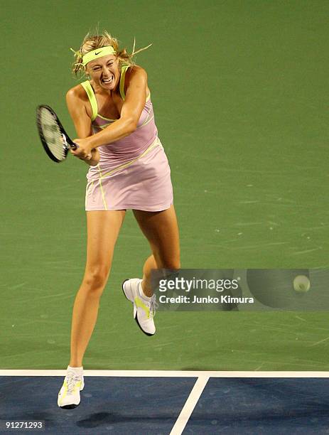 Maria Sharapova of Russia plays a backhand in her match against Alisa Kleybanova of Russia during day four of the Toray Pan Pacific Open Tennis...