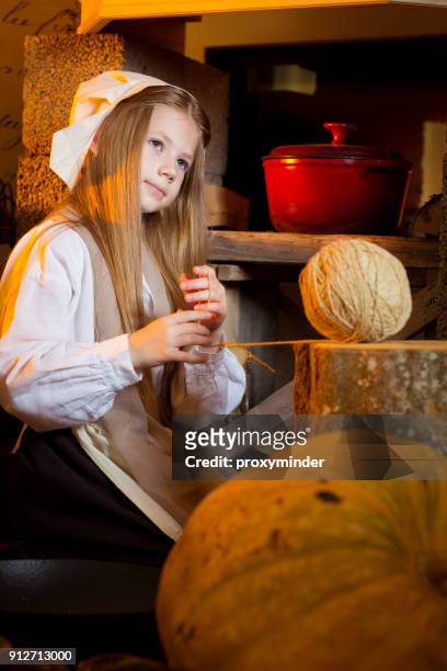cinderella near fireplace working in kitchen - latvia girls stock pictures, royalty-free photos & images