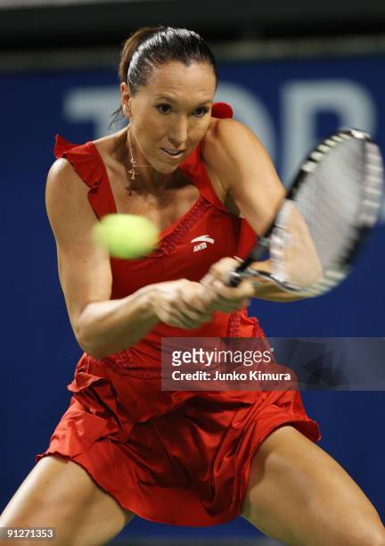 Jelena Jankovic of Serbia plays a backhand in her match against Elena Vesnina of Russia during day four of the Toray Pan Pacific Open Tennis...