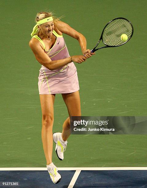 Maria Sharapova of Russia plays a backhand in her match against Alisa Kleybanova of Russia during day four of the Toray Pan Pacific Open Tennis...