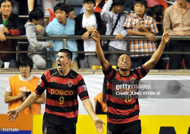 Martins Nascimento Denilson of South Korea's Pohang Steelers celebrates his goal with teammate Stevo against Uzbekistan's Bunyodkor during their...