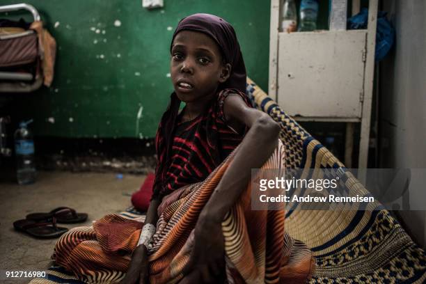 Faysa Hasan sits on the floor of emergency ward of Borama Regional Hospital in Somalia on March 21, 2017. Faysa was admitted to the hospital weighing...