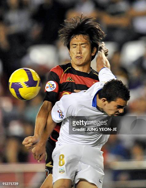 No Byung-Jun of South Korea's Pohang Steelers vies for the ball with Silva Edson Ramos of Uzbekistan's Bunyodkor during their quarter-final football...