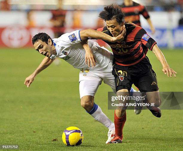 Shin Hyung-Min of South Korea's Pohang Steelers vies for the ball with Joao Victor Albuquerque Bruno of Uzbekistan's Bunyodkor during their...