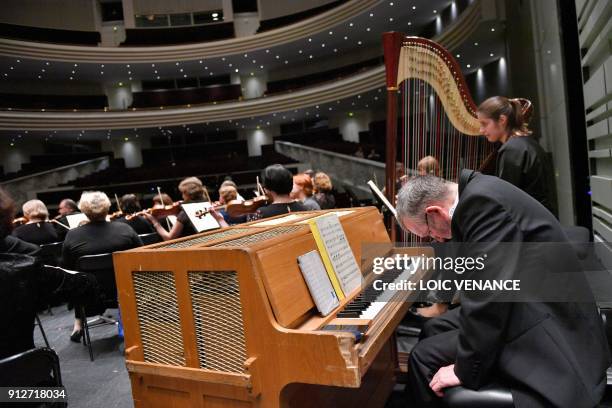 Musicians of the Ural Philharmonic Orchestra playing the piano and the harp look on during a rehearsal a musical piece composed by Russian composer...