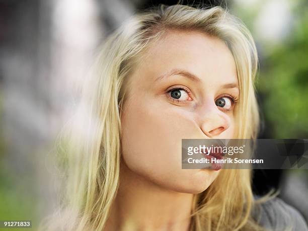 young woman with face against window - woman mouth stock-fotos und bilder