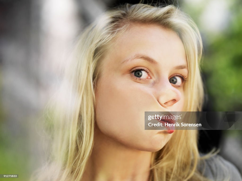 Young woman with face against window