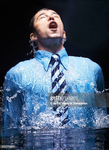 businessman breaking the watersurface - business appearance stock pictures, royalty-free photos & images