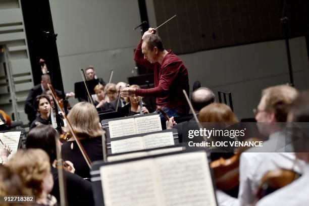 Russian director Dmitri Liss directs musicians of the Ural Philharmonic Orchestra during a rehearsal of a musical piece composed by Russian composer...