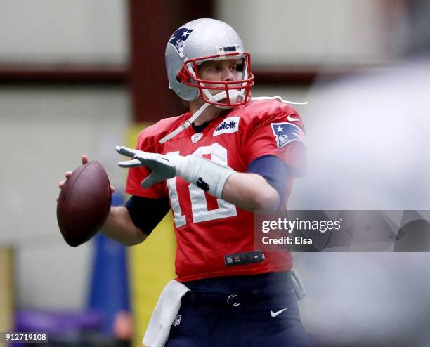 Tom Brady of the New England Patriots warms up during the New England Patriots practice on January 31, 2018 at Winter Park in Eden Prairie,...