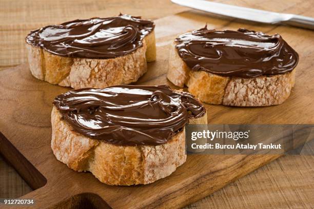 chocolate spread on bread - nutella stock pictures, royalty-free photos & images