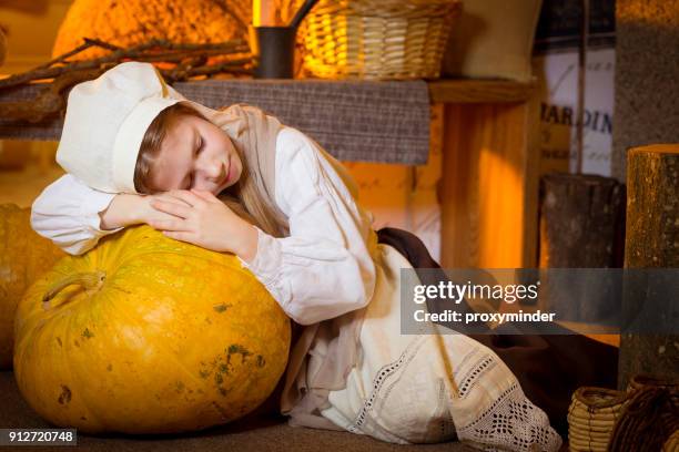 cinderella near fireplace rest after hard work - cinderella stock pictures, royalty-free photos & images