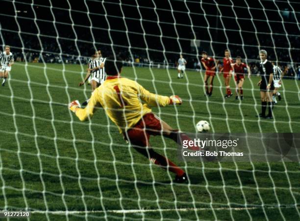 Michel Platini of Juventus beats goalkeeper Bruce Grobbelaar to score the only goal of the game during the Liverpool v Juventus European Cup Final...