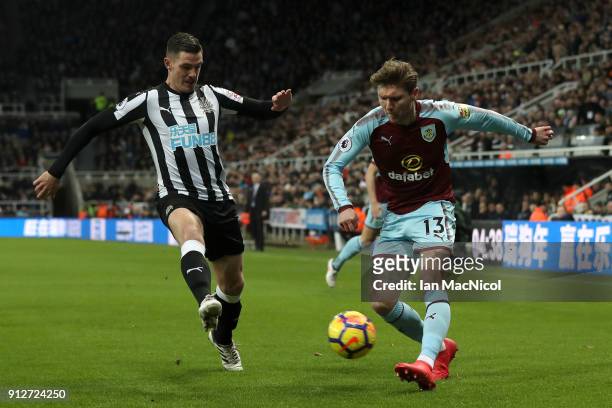 Jeff Hendrick of Burnley attempts to cross as Ciaran Clark of Newcastle United attempts to block during the Premier League match between Newcastle...