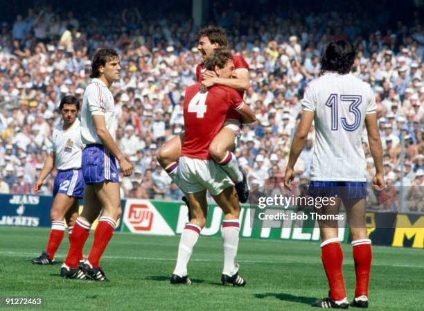Bryan Robson of England is lifted off the ground by team-mate Terry Butcher after scoring a goal within the first 30 seconds of the England v France...