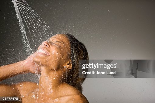 Shower stream of water on models face Shower stream of water on models face