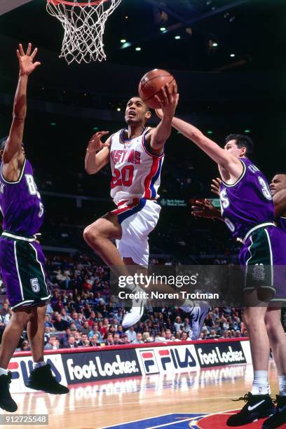 Allan Houston of the Detroit Pistons shoots during a game played on February 27, 1995 at the Palace of Auburn Hills in Auburn Hills, Michigan. NOTE...