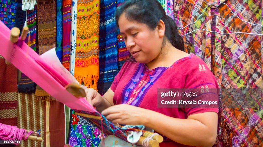 Woman weaving with a backstrap loom at Handicraft Market