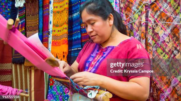 woman weaving with a backstrap loom at handicraft market - guatemala bildbanksfoton och bilder