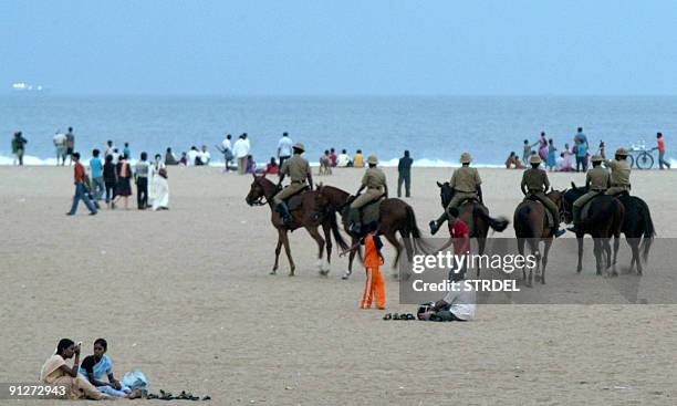 Mounted Indian policemen patrol along Marina Beach in Chennai on September 30 after an earthquake in Indonesia triggered fears of a tsunami. At least...