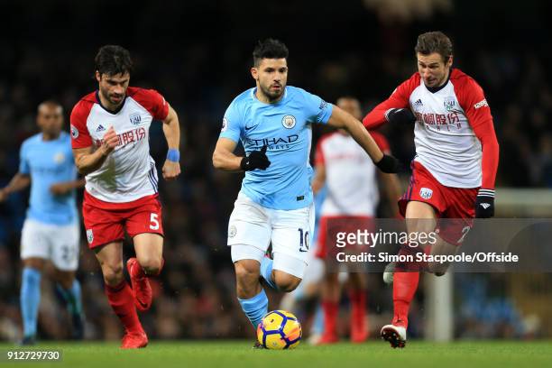 Sergio Aguero of Man City battles with Claudio Yacob of West Brom and Grzegorz Krychowiak of West Brom during the Premier League match between...